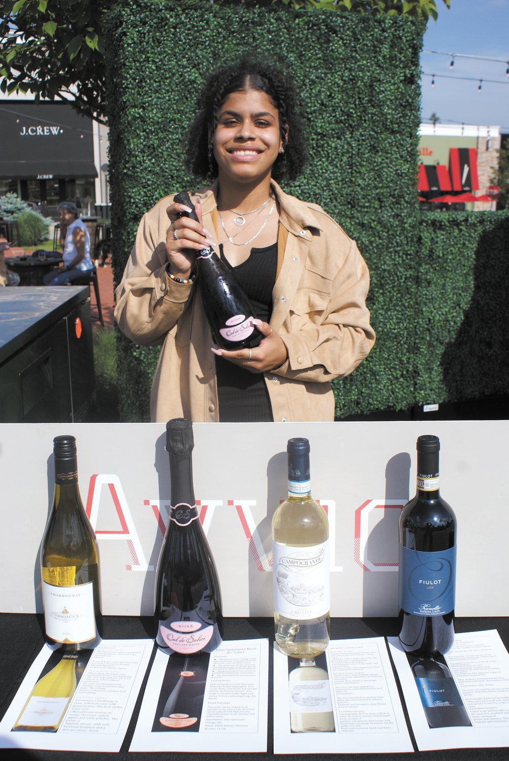 GOOD SELECTION: Avvio’s server Yomi Mendez poses with a selection of wines from one of this season’s Sip and Shop events: Tormaresca Vino Spumante Rose, Campogrande Orvieto and Barbara D’Asti Firlot. (Photo by Steve Popiel)